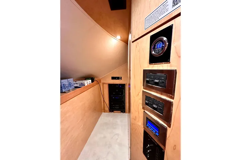 Slide: The Image of 2019 Viking 68 Convertible yacht interior with control panels and storage area. - 9
