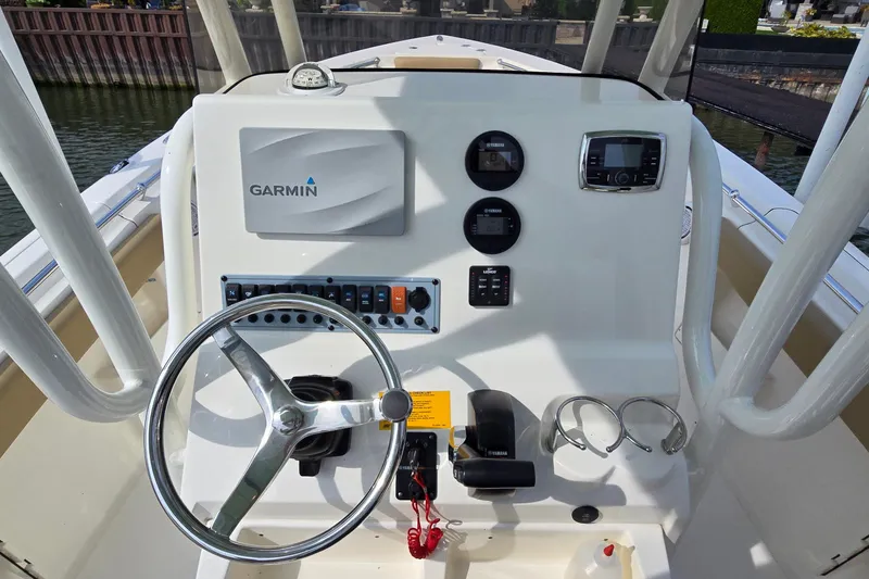 Slide: The Image of 2020 Key West 239 FS boat dashboard with Garmin navigation system and steering wheel. - 11