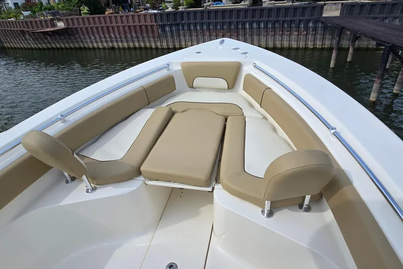 Slide: The Image of 2020 Key West 239 FS boat with tan cushioned seating, docked by a wooden pier. - 14