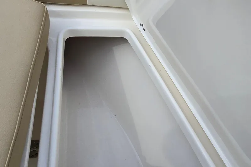 Slide: The Image of Storage compartment in 2020 Key West 239 FS boat, featuring beige seating and white interior. - 19