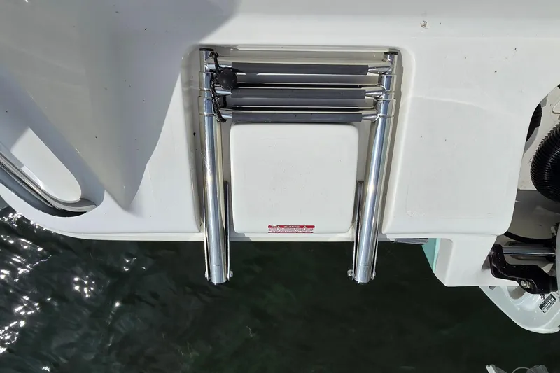 Slide: The Image of 2020 Key West 239 FS boat ladder, folded, over water. - 25