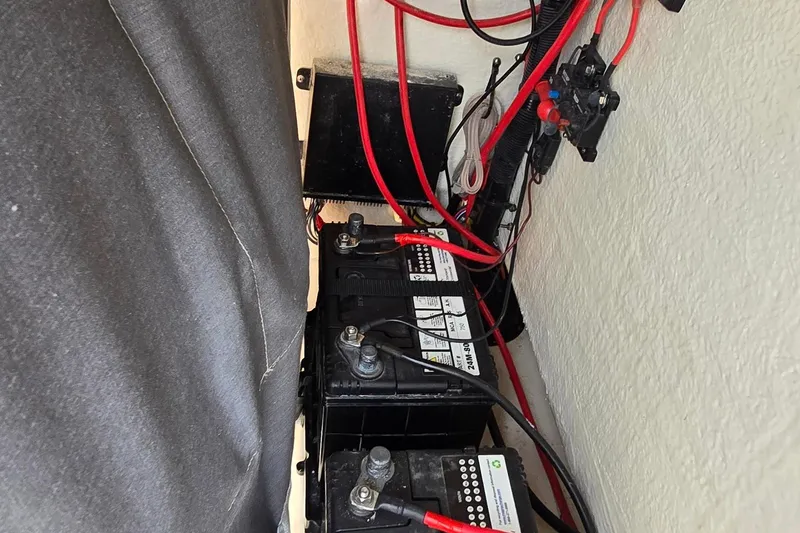 Slide: The Image of Battery compartment of a 2020 Key West 239 FS boat with wiring and connections. - 30