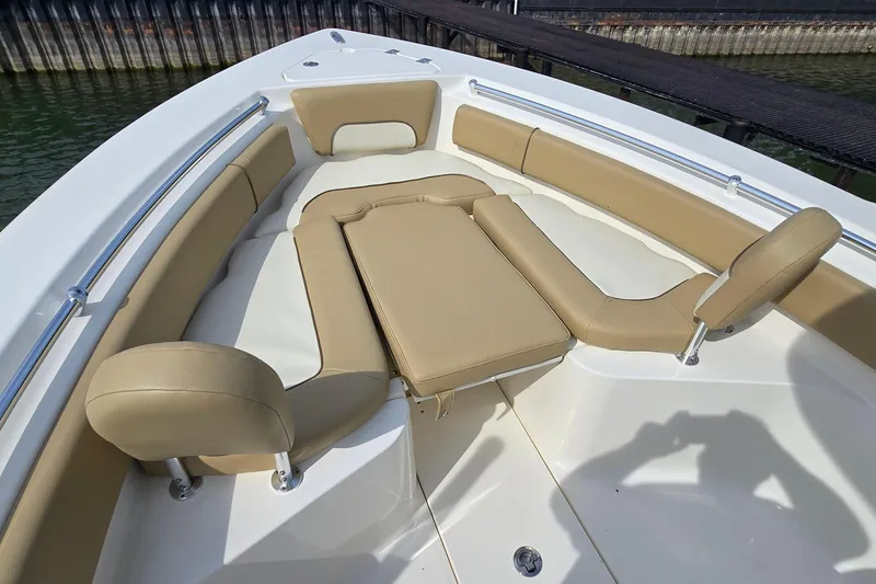 Slide: The Image of 2020 Key West 239 FS boat interior with tan cushioned seating and white deck. - 32