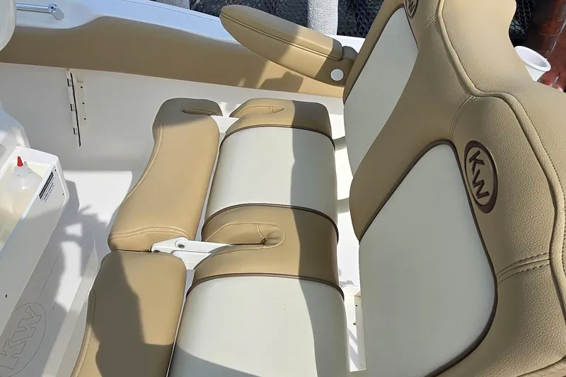 Slide: The Image of 2020 Key West 239 FS boat interior with tan and white cushioned seating. - 33