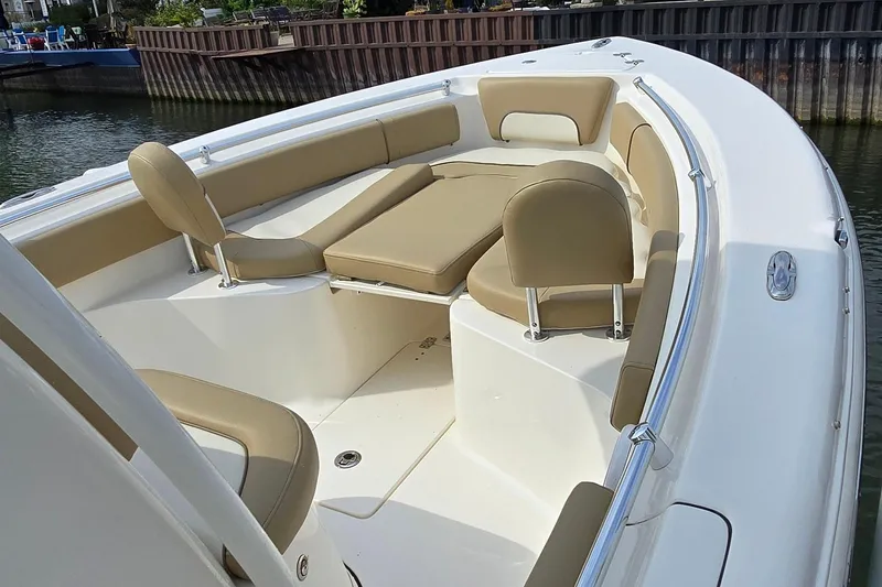 Slide: The Image of 2020 Key West 239 FS boat interior with beige seating and white deck. - 4