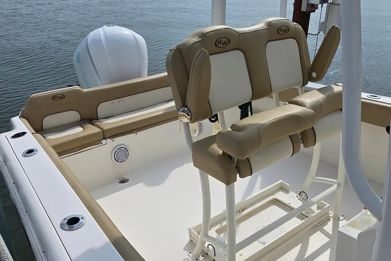 Slide: The Image of 2020 Key West 239 FS boat interior with tan and white seating, docked on water. - 5