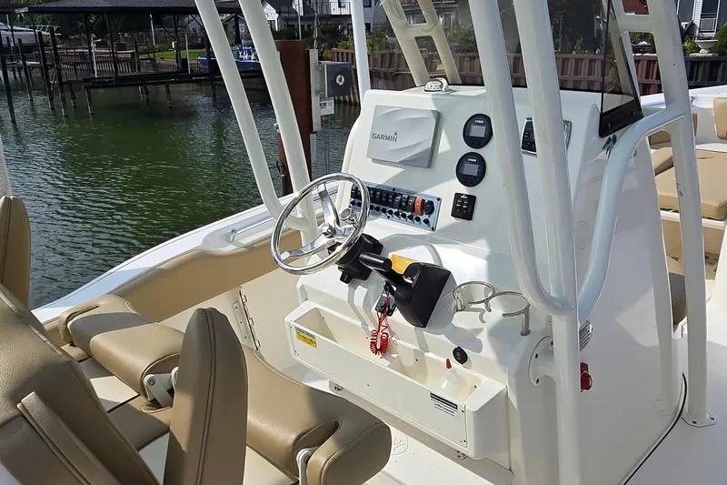 Slide: The Image of 2020 Key West 239 FS boat cockpit with Garmin navigation system and beige seating. - 7