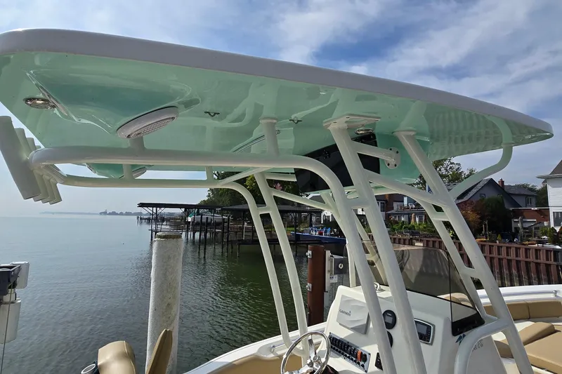Slide: The Image of 2020 Key West 239 FS boat with T-top, docked by a serene waterfront. - 8