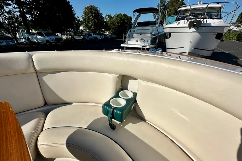 Slide: The Image of 2002 Chris-Craft Launch 28 boat interior with cream leather seating and cup holders. - 10