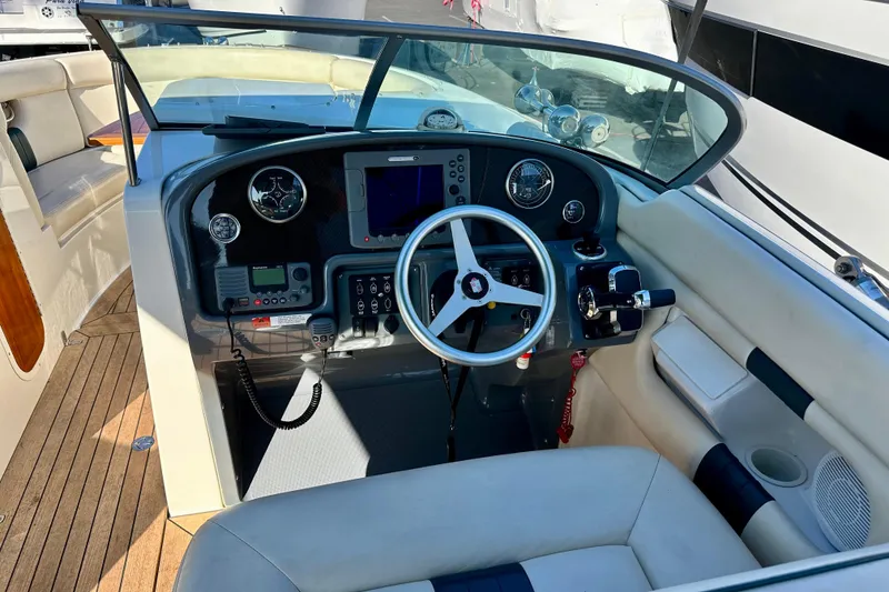 Slide: The Image of 2002 Chris-Craft Launch 28 boat cockpit with steering wheel and control panel. - 11