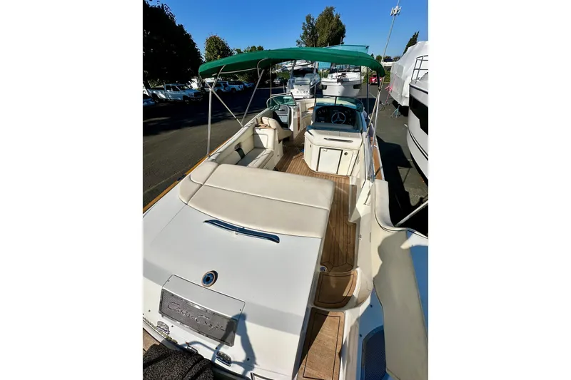 Slide: The Image of 2002 Chris-Craft Launch 28 boat with green canopy and spacious deck. - 14
