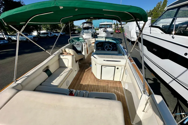 Slide: The Image of 2002 Chris-Craft Launch 28 boat with green canopy and spacious seating area. - 2