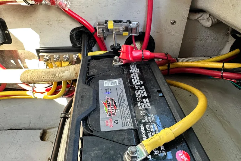Slide: The Image of Battery setup in a 2002 Chris-Craft Launch 28 boat, featuring Interstate battery and wiring. - 24