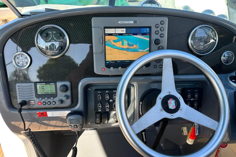 Slide: The Image of 2002 Chris-Craft Launch 28 dashboard with navigation system and steering wheel. - 39
