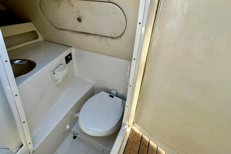 Slide: The Image of 2002 Chris-Craft Launch 28 boat interior with compact bathroom and toilet. - 9