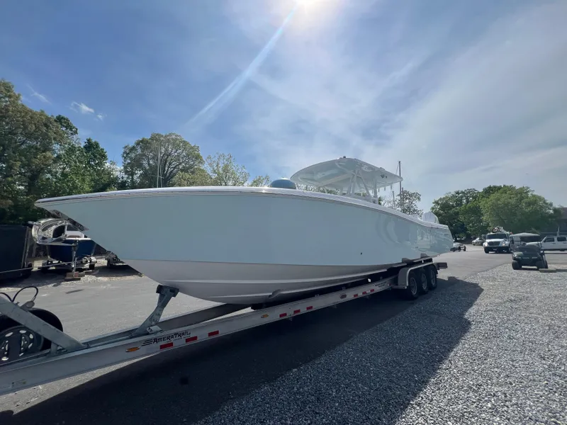 Slide: The Image of 2024 Invincible 39 Open Fisherman boat on a trailer in a parking lot. - 4