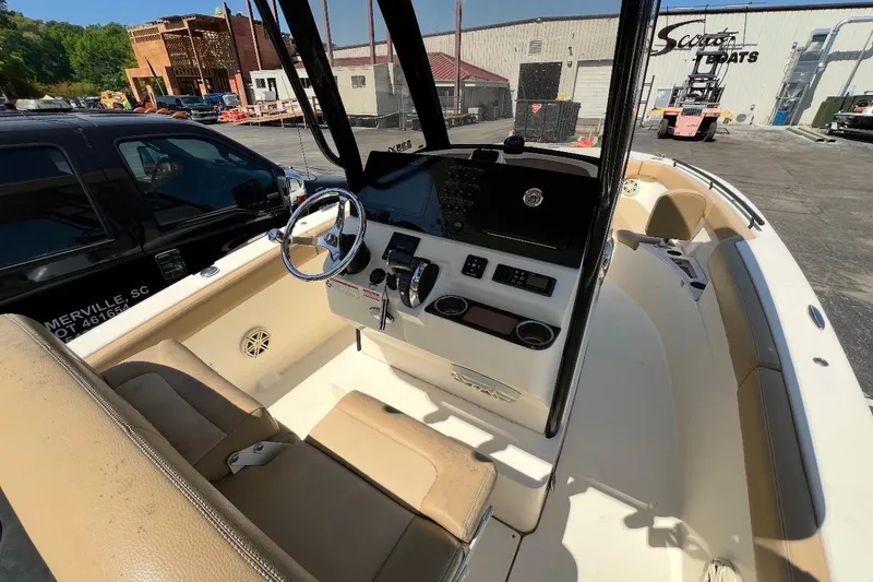 Slide: The Image of 2021 Scout 235 XSF boat interior with steering wheel and control panel. - 4
