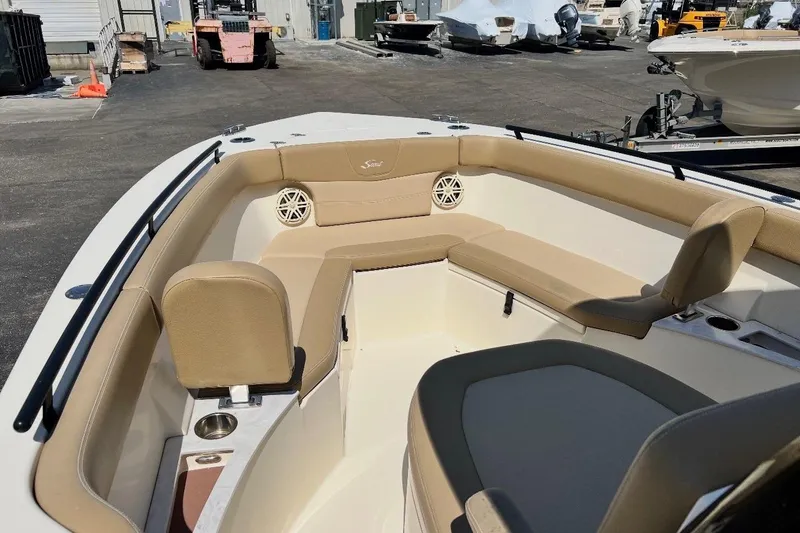 Slide: The Image of 2021 Scout 235 XSF boat interior with beige seating and cup holders. - 7