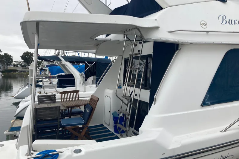 Slide: The Image of 1999 Bayliner 3388 Command Bridge Motoryacht docked with outdoor seating area. - 14