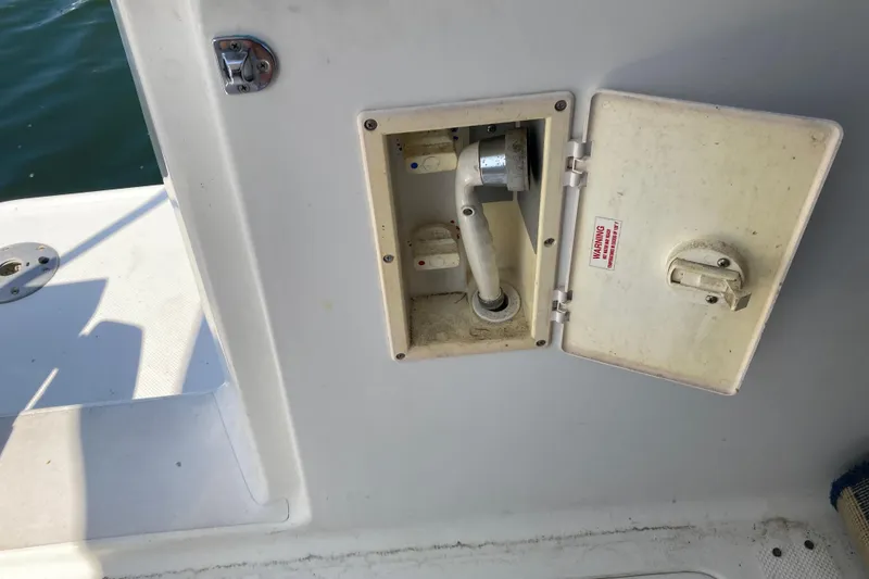 Slide: The Image of 1999 Bayliner 3388 Command Bridge Motoryacht water inlet compartment with open access panel. - 16