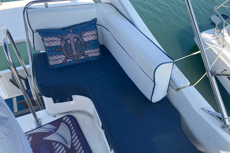 Slide: The Image of 1999 Bayliner 3388 Command Bridge Motoryacht seating area with nautical-themed cushion. - 26