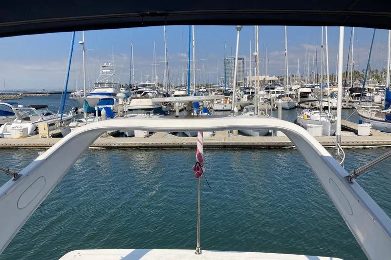 Slide: The Image of 1999 Bayliner 3388 Command Bridge Motoryacht docked in a busy marina. - 28