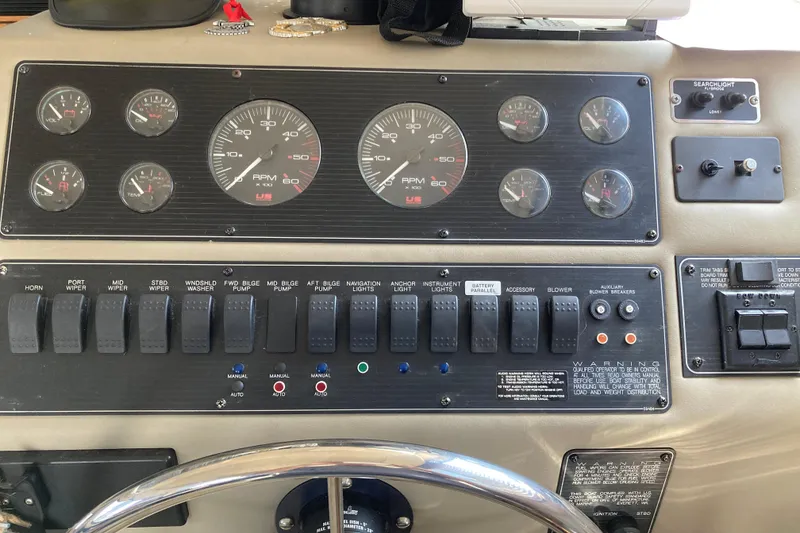Slide: The Image of 1999 Bayliner 3388 Command Bridge Motoryacht dashboard with gauges and control switches. - 33