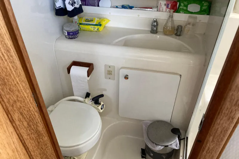Slide: The Image of 1999 Bayliner 3388 Command Bridge Motoryacht bathroom with toilet, sink, and toiletries. - 40