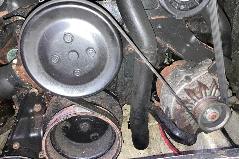 Slide: The Image of Engine components of a 1999 Bayliner 3388 Command Bridge Motoryacht, showing belts and pulleys. - 49