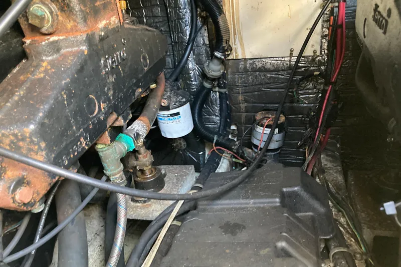 Slide: The Image of Engine compartment of a 1999 Bayliner 3388 Command Bridge Motoryacht, showing mechanical components. - 52