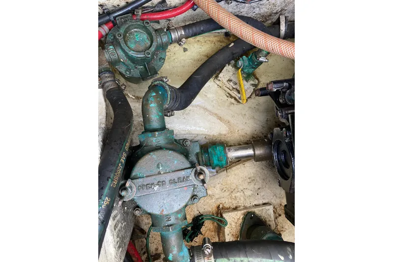 Slide: The Image of Engine compartment of 1999 Bayliner 3388 Command Bridge Motoryacht, showing mechanical components. - 54