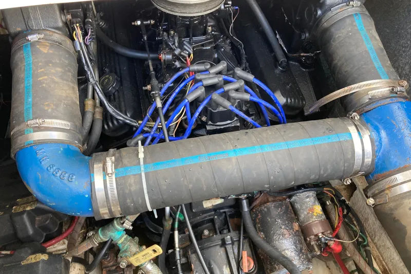 Slide: The Image of Engine compartment of a 1999 Bayliner 3388 Command Bridge Motoryacht with visible hoses and wiring. - 57