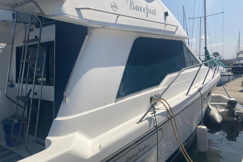 Slide: The Image of 1999 Bayliner 3388 Command Bridge Motoryacht docked at marina, side view. - 6