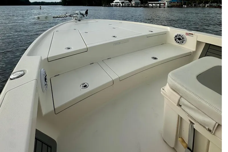 Slide: The Image of 2019 Pathfinder 2500 Hybrid boat on calm water under cloudy sky. - 14