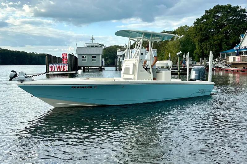 Slide: The Image of 2019 Pathfinder 2500 Hybrid boat on calm water under a partly cloudy sky. - 3