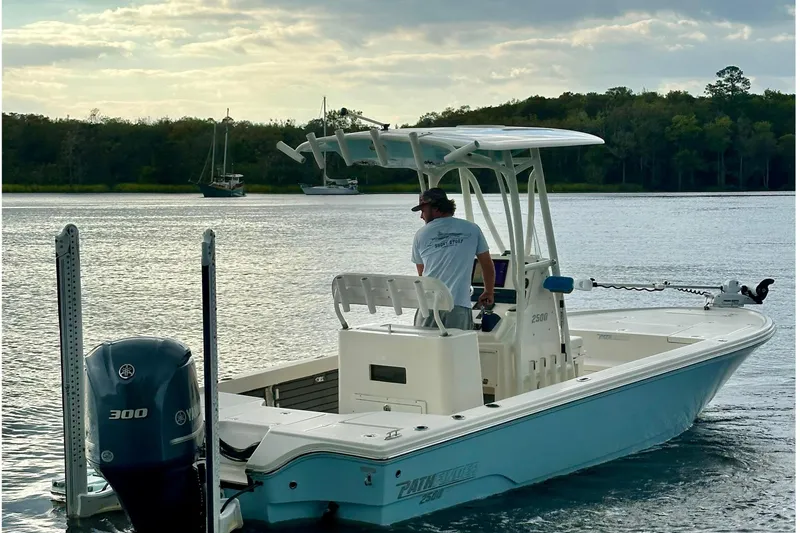 Slide: The Image of 2019 Pathfinder 2500 Hybrid boat on calm water under cloudy sky. - 5
