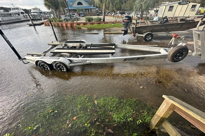 Slide: The Image of Boat trailer partially submerged at a marina, near a Pathfinder 2500 Hybrid, 2019 model. - 8