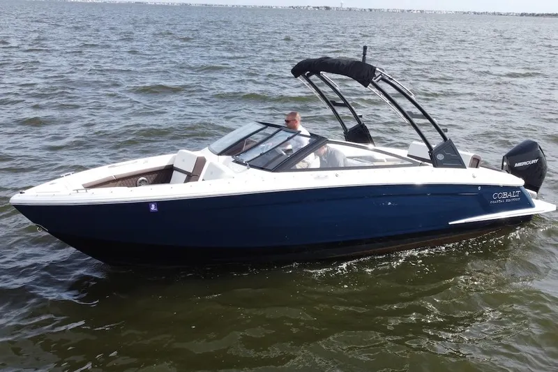 The Image of 2024 Cobalt R4 Outboard boat cruising on open water. - 1