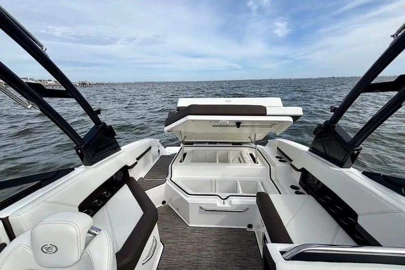 Slide: The Image of 2024 Cobalt R4 Outboard boat interior with open storage, on a calm sea. - 14