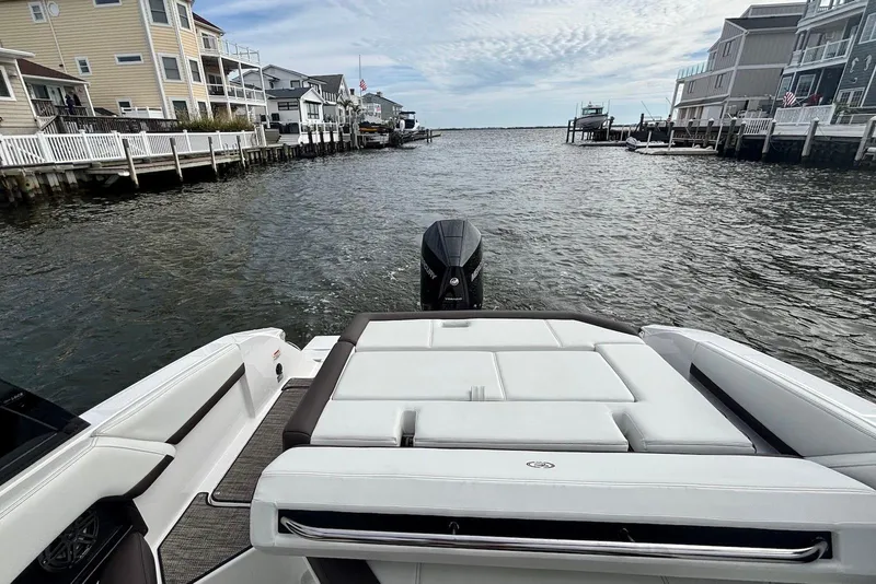 Slide: The Image of 2024 Cobalt R4 Outboard boat on water near waterfront homes, showcasing luxury seating. - 18