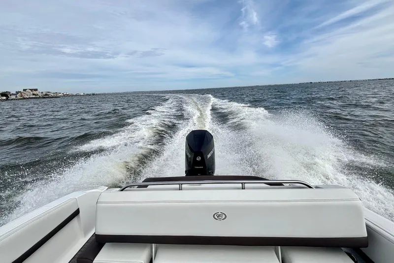 Slide: The Image of 2024 Cobalt R4 Outboard boat cruising on open water, leaving a wake behind. - 20