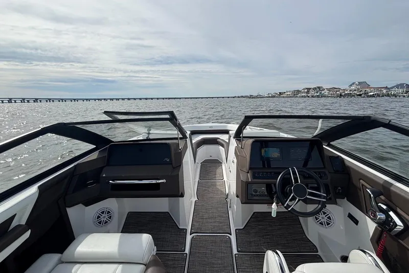 Slide: The Image of 2024 Cobalt R4 Outboard boat interior with steering wheel, dashboard, and open water view. - 5