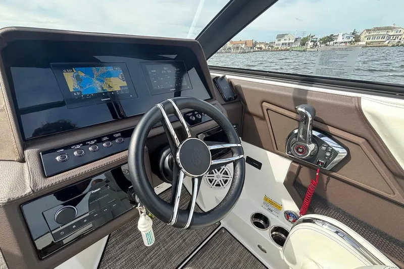 Slide: The Image of 2024 Cobalt R4 Outboard dashboard with steering wheel, navigation screens, and controls. - 9