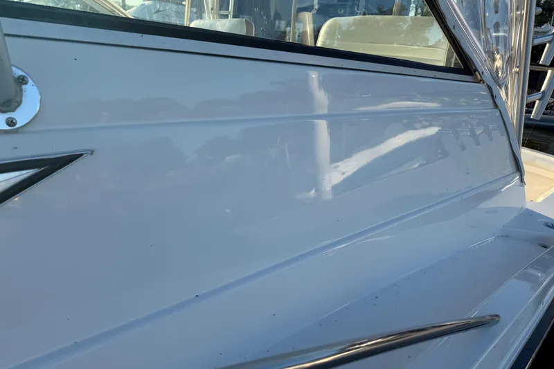 Slide: The Image of Close-up of 1997 Wellcraft 3300 Coastal boat exterior, showcasing sleek white hull design. - 6