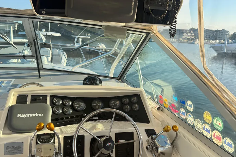 Slide: The Image of 1997 Wellcraft 3300 Coastal boat dashboard with Raymarine equipment, docked in a marina. - 9