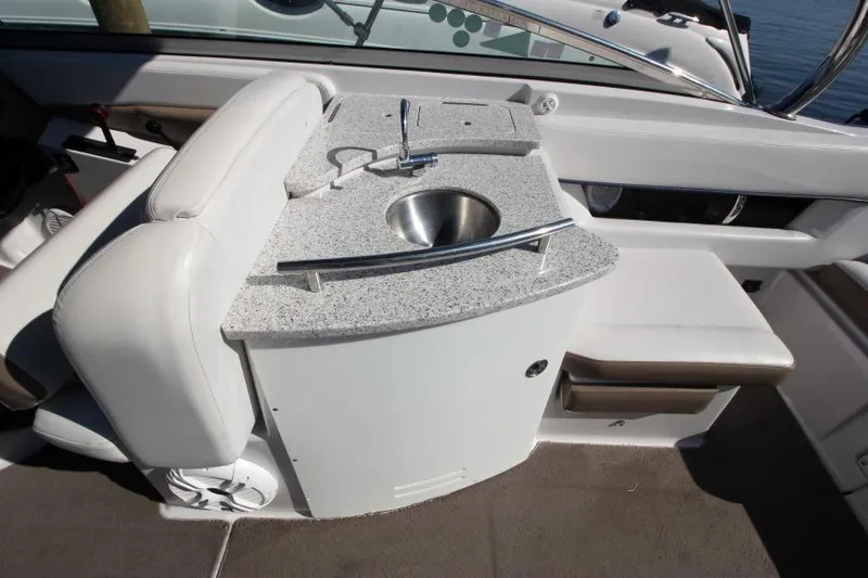 Slide: The Image of 2008 Four Winns 310 Horizon boat interior with sink and seating area. - 10