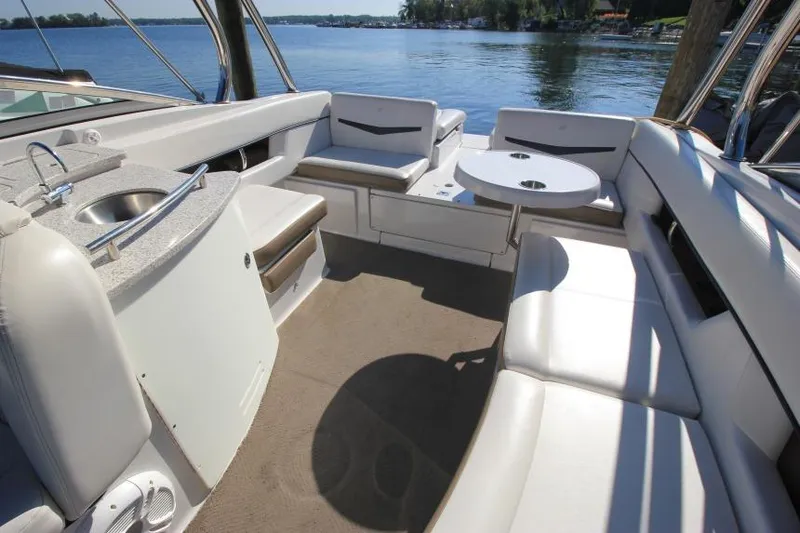 Slide: The Image of Interior of 2008 Four Winns 310 Horizon boat with seating and sink, overlooking a lake. - 12