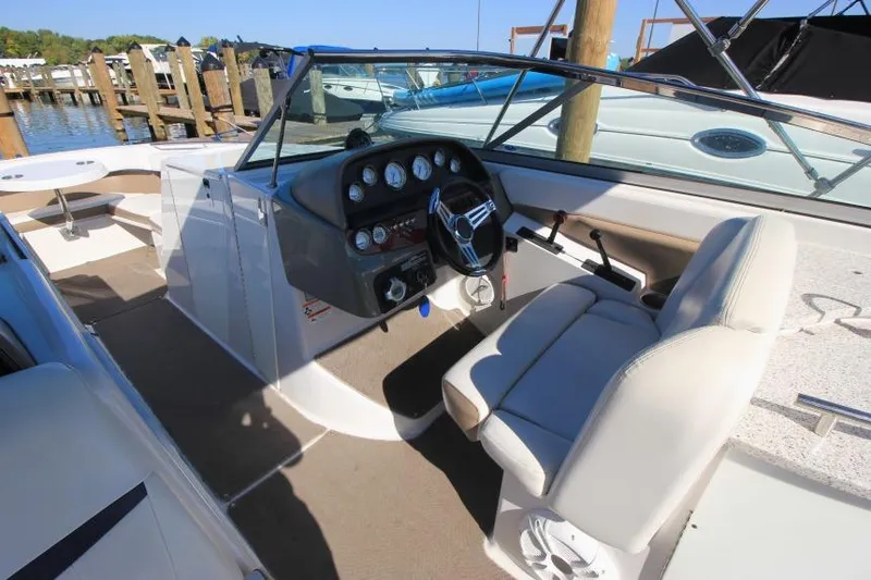 Slide: The Image of 2008 Four Winns 310 Horizon boat cockpit with steering wheel and gauges. - 13