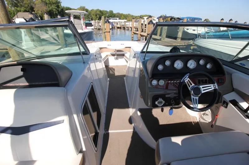 Slide: The Image of 2008 Four Winns 310 Horizon boat interior with steering wheel and dashboard, docked at marina. - 17