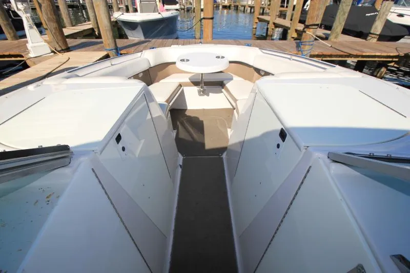 Slide: The Image of 2008 Four Winns 310 Horizon boat interior with seating and table at dock. - 18